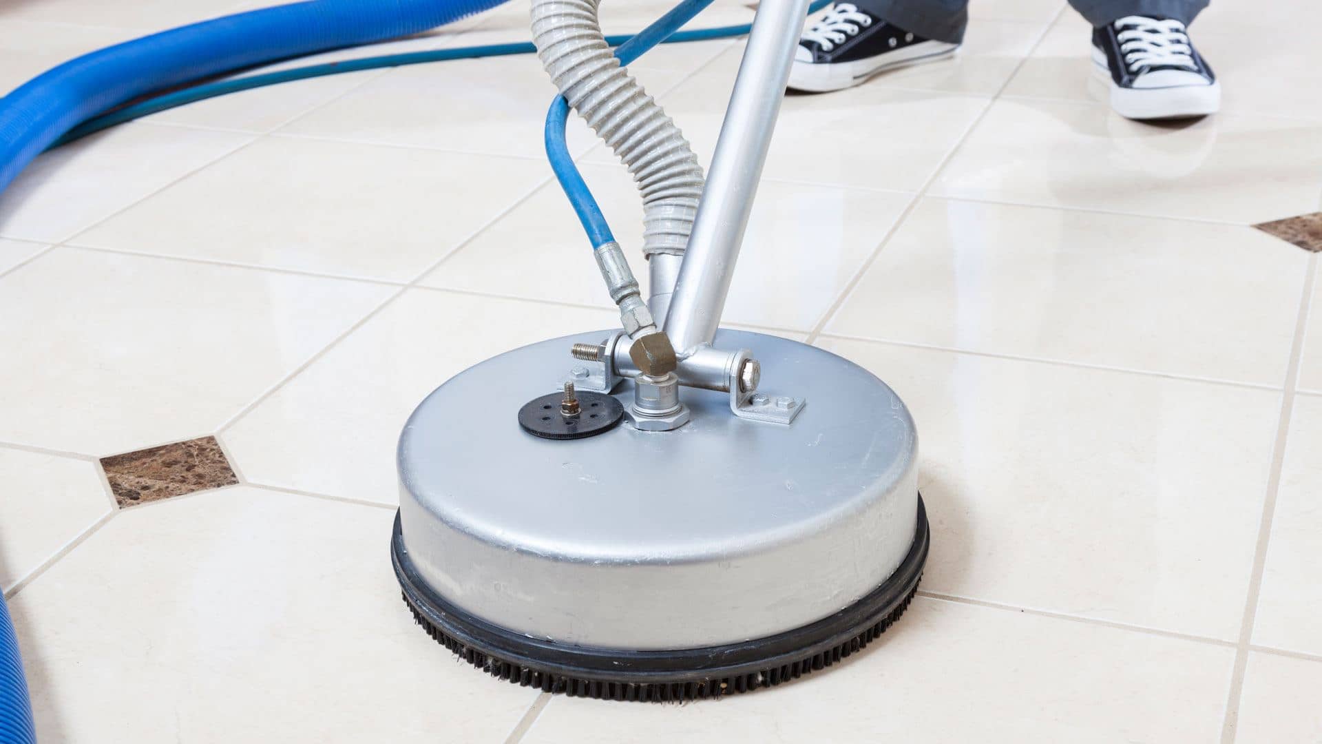 Spinner tool cleaning a white tile floor